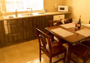 a kitchen with a table and a kitchen with a sink at Atlantic View Apartments in Limavady