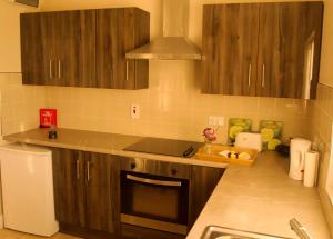 a kitchen with wooden cabinets and a counter top at Atlantic View Apartments in Limavady