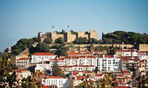 a town with a castle on top of a hill at Lisbon Prime Hostel & Rooms in Lisbon