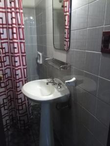 a bathroom with a sink and a mirror at La Casa de Teresa in Colonia del Sacramento +19 photos