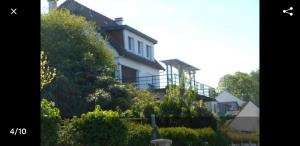 a house on the side of a hill with trees at Monatella in Criel-sur-Mer