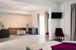 a living room with a couch and a table at Stavros Beach Hotel in Stavros