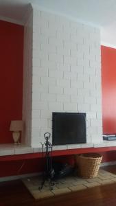 a flat screen tv sitting on a white wall at Varanda do Atlântico in Ponta Delgada