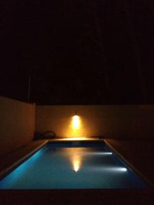 una piscina en una habitación oscura con luz en Ayres de mar en Balneario Claromecó