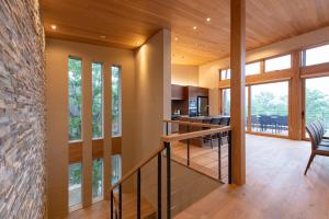 uma casa com uma escada que leva à cozinha e sala de estar em Soseki em Niseko