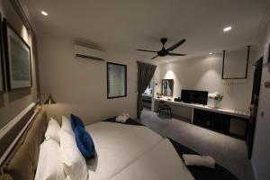 a bedroom with a bed and a ceiling fan at Manhattan Residence in George Town