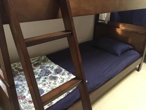 a couple of bunk beds with a small bed at Shimaotoya in Iriomote