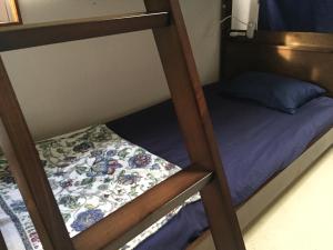 a couple of bunk beds with a small bed at Shimaotoya in Iriomote