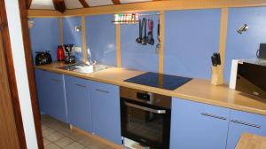 a kitchen with blue cabinets and a counter top at Waldeck in Frankenau