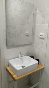 a bathroom with a white sink and a mirror at Wellness Apartments Ra in Primošten +84 photos