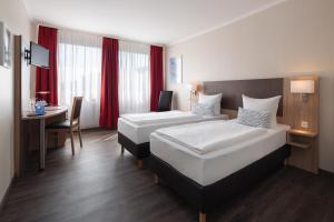 Postel nebo postele na pokoji v ubytování Hotel Berliner Bär