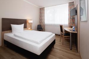 Postel nebo postele na pokoji v ubytování Hotel Berliner Bär