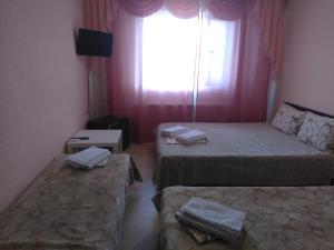 Korenovsk的住宿－Лиманский，客房设有两张床和窗户。