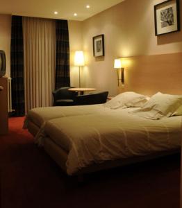 Postel nebo postele na pokoji v ubytování Hotel Escapade