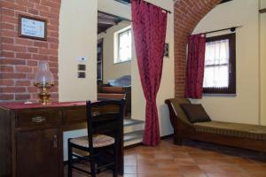 a room with a desk and a chair and a couch at Casa Del Grande Vecchio in Airasca