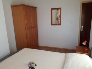a bedroom with a bed with a flower on it at Apartment Andrea in Orebić