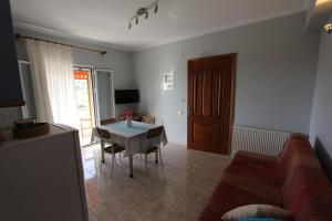 a living room with a table and a couch at Tosis Apartments in Svoronata