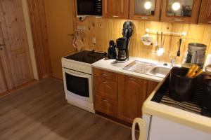 a kitchen with a white stove top oven next to a sink at Sir Gamle Skole Holstebro in Holstebro