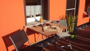 a table with two chairs and a glass of wine at Wildholz Sachsen in Weidenhain