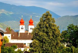 a castle with red domes on top of a tree at Landhaus Tangern in Millstatt