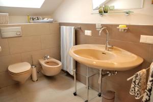 a bathroom with a sink and a toilet at Landhaus Tangern in Millstatt