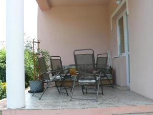a group of chairs sitting on a patio at Hejő Apartman in Miskolctapolca