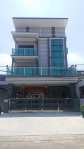 a large building with a balcony on top of it at CK Homestay K.Sepetang in Taiping
