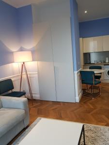 a living room with a couch and chairs and a table at Tres Bel Appartement Vieux Port De Bastia in Bastia