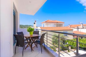 a balcony with a table and chairs and a view at Villa Tasos-Potos Thassos in Potos