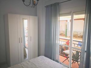 Ένα ή περισσότερα κρεβάτια σε δωμάτιο στο Apartamentos El Barrio