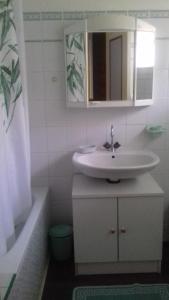 a bathroom with a sink and a tub and a mirror at La Grange in Le Plan +21 photos