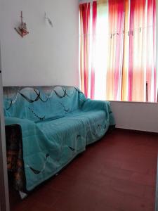 a bed sitting in a room with a window at Arrifana Summer Flat in Aljezur