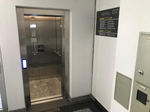 a bathroom with a door open and a door open at Hotel CITY in Prnjavor