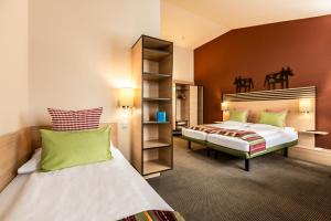 Letto o letti in una camera di TUI BLUE Schladming