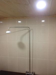 a shower with a glass door in a bathroom at Hostel One in Lankaran