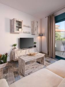 a living room with a television and a table at Villa Tasos-Potos Thassos in Potos