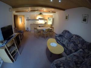 a living room with a couch and a table at Gastehaus Reichle in Tannheim