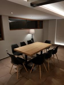 a conference room with a wooden table and chairs at Mihaylova kushta in Lyubosh +39 photos