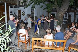 a bride and groom dancing in front of a group of people at Hotel Legende in Samarkand