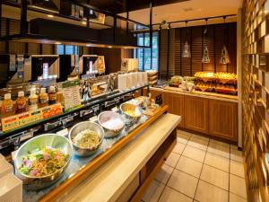 a restaurant with bowls of food on a counter at Super Hotel Shinyokohama in Yokohama