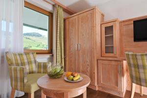 a room with a table with a bowl of fruit on it at Hotel Rössle in Bernau im Schwarzwald