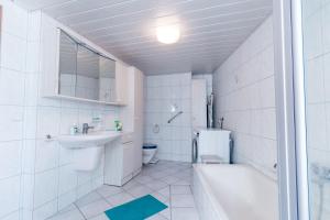 a white bathroom with a sink and a toilet at Ferienwohnung Andrea in Pohl