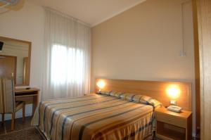 Postel nebo postele na pokoji v ubytování Hotel Moderno