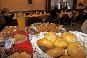 a table topped with lots of different types of bread at Garni Halali in Ortisei