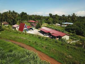 an overhead view of a farm with a road and a building at Panorama Homestay in Jeram