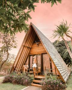 a small house with people standing outside of it at Batan Sabo Cottage in Nusa Penida