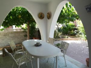 a white table and chairs on a patio at Llar Montagut in Torredembarra