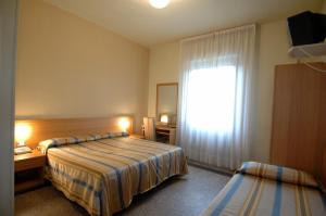Postel nebo postele na pokoji v ubytování Hotel Moderno