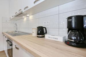 a kitchen with a counter with a coffee maker on it at Two new apartments by the town center in Zadar