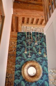a room with a green wall with a mirror at La Casa Jungle Bed & Spa - Pentes de la Croix Rousse in Lyon